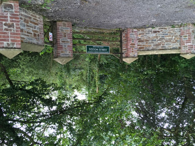 Brick wall and wooden gates. Entrance to Jubilee Woods.